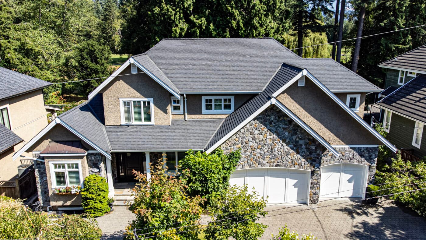 Full front elevation of the Coquitlam residence with light trim and garage doors