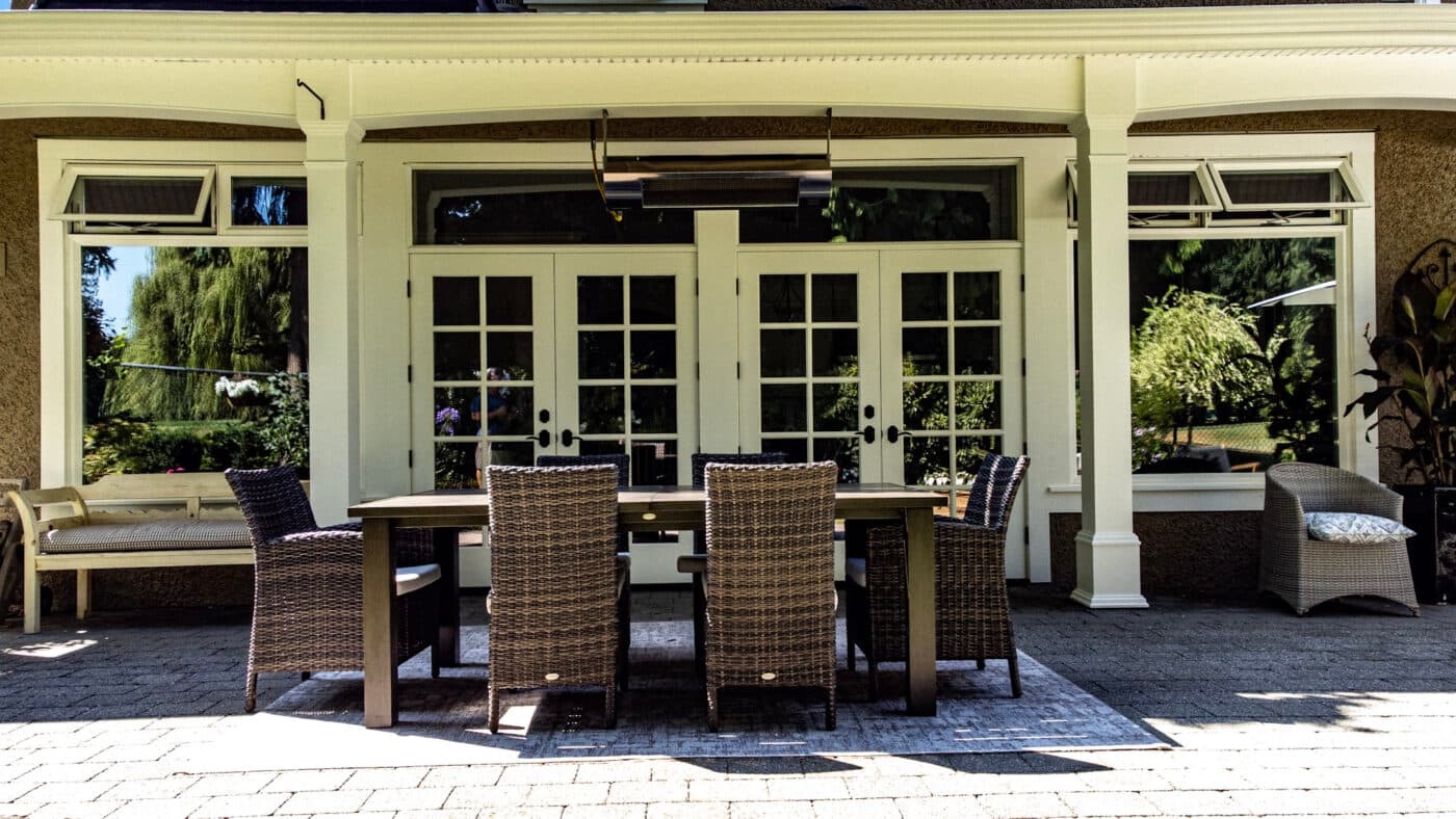 Covered patio with white columns, trim and French doors at the Coquitlam residence